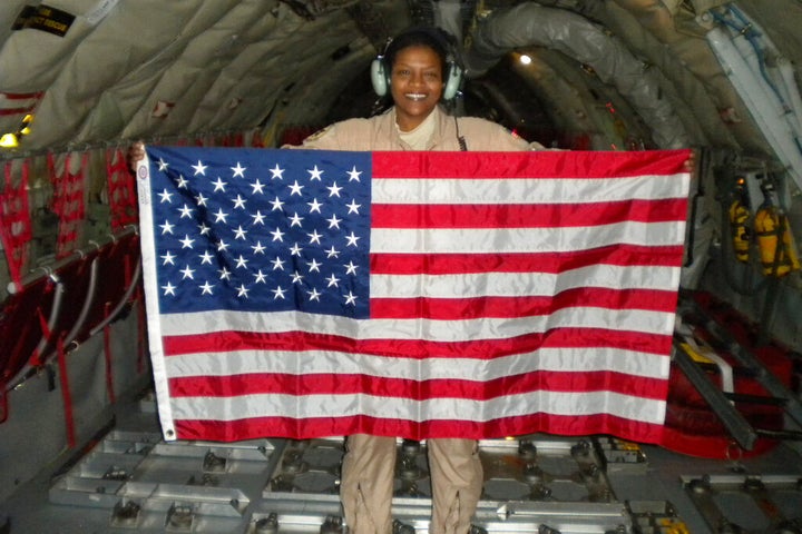 Retired Air Force Lt. Col. Stephanie Davis holds a U.S. flag in the cargo area of a KC-135 airplane while flying over Pakistan/Afghanistan. For Davis, who grew up poor, the military was a path to the American dream, a realm where everyone would receive equal treatment. But many of her service colleagues, Davis says, saw her only as a Black woman. Or for the white resident colleagues who gave her the call sign of ABW â it was a joke, they insisted â an âangry black woman,â a classic racist trope. (Courtesy Stephanie Davis via AP)