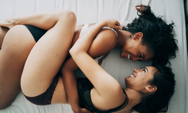 Two beautiful sexy women lesbian couple in the bed