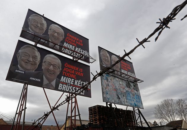 BUDAPEST, HUNGARY - FEBRUARY 22:  A billboard seen with portraits of European Commission chief Jean-Claude Juncker  and Hungarian-born US billioner George Soros and a slogan reading 