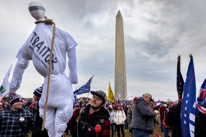 A pro-Trump protestor holds an effigy with a noose around its neck at Trump's rally that preceded the insurrection.