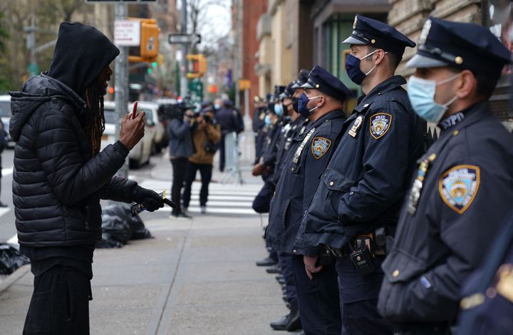 A protester approaches NYPD officers at an April demonstration. NYPD officers say that they do less proactive policing for fe