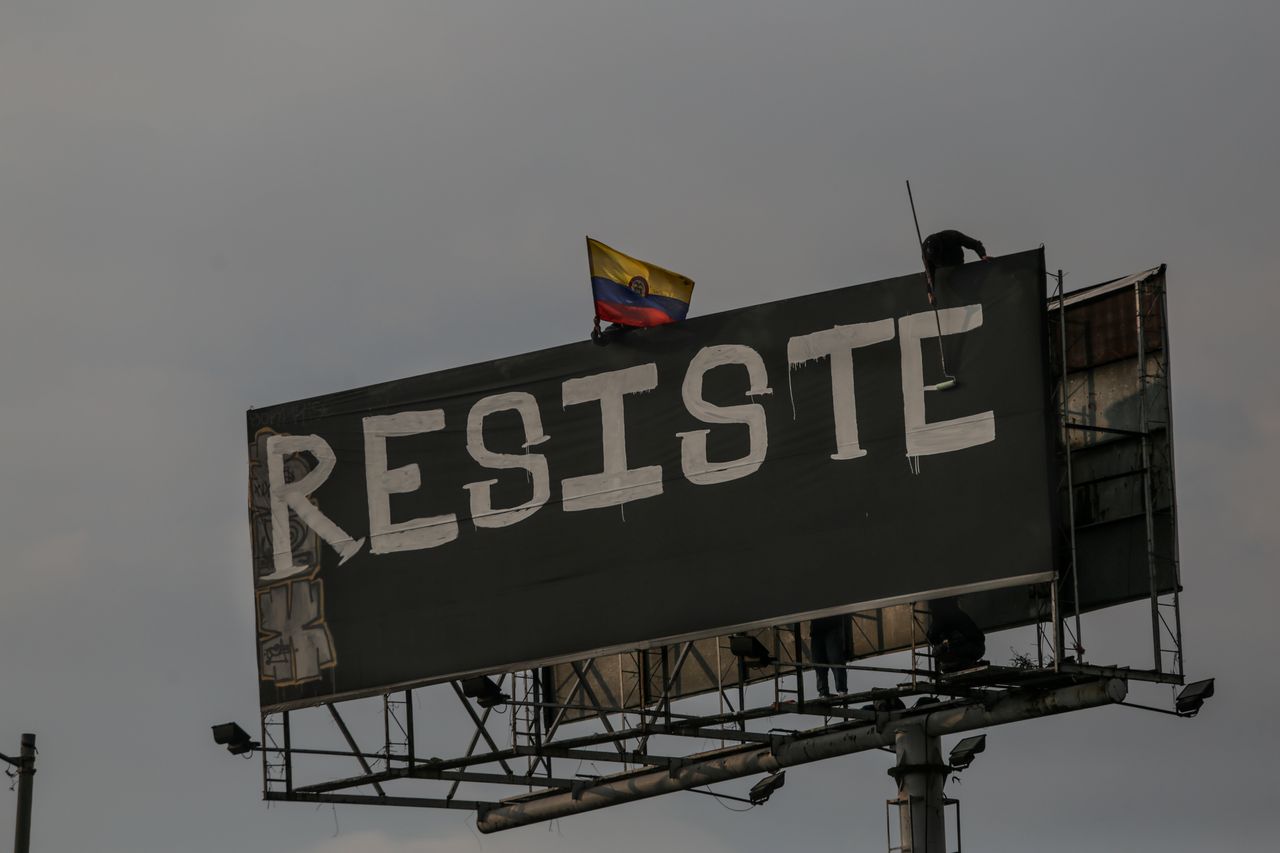 BOGOTA, COLOMBIA - MAY 29: Protesters perform in front of the Portal de las Americas station, rename as "Portal Resistance" during a national strike in Bogota, Colombia, on May 29, 2021. Tens of thousands of Colombians have taken to the streets in demonstrations that began on âApril 28 have paralyzed Colombia, with demonstrators originally taking to the streets against proposed tax reform. While the tax plan was later withdrawn by the government, protesters are now demanding health, educational, and policy reforms. The protests have shown no sign of stopping, and police and armed forces continue to respond with lethal violence as the nights fall in different cities in the country. (Photo by Juancho Torres/Anadolu Agency via Getty Images)