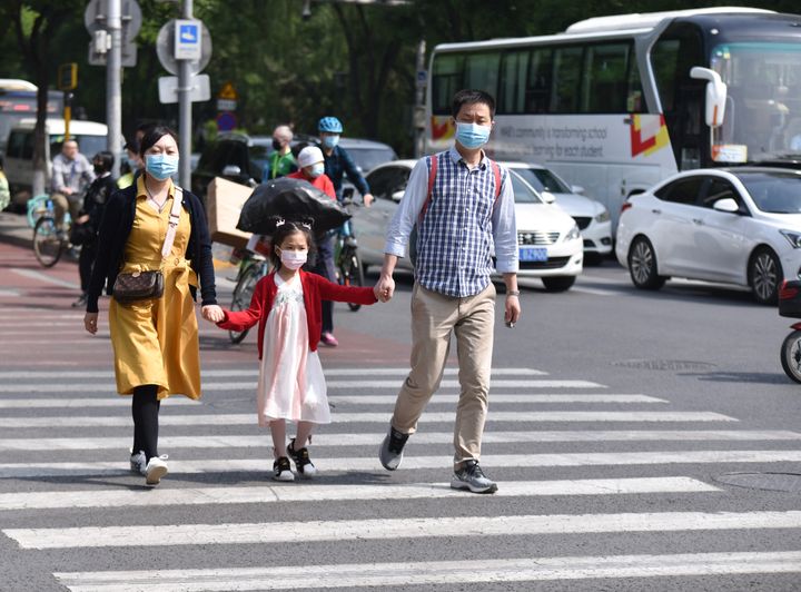 Parents with their kid walk along the Streets of Beijing. China's population has continued to grow since 2020, the National Bureau of Statistics said. (Photo by Sheldon Cooper/SOPA Images/LightRocket via Getty Images)