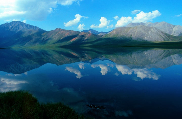 The Brooks Range mountains reflect off Schrader Lake in Alaska's Arctic National Wildlife Refuge.
