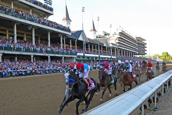 Medina Spirit (8) ridden by jockey John Velazquez leads on the front stretch and goes on to win the 147th Running of the Kent