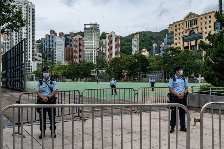 Police stand on patrol at Victoria Park, after closing a venue where Hong Kong people traditionally gather annually to mourn the victims of the Tiananmen Square crackdown, in the Causeway Bay district on June 4, 2021, in Hong Kong.