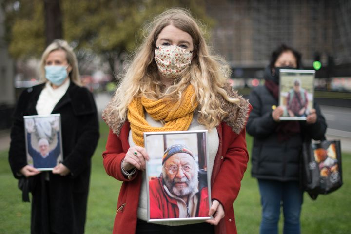Jo Goodman, who lost her father Stuart, 72, to COVID 19 stands with other families bereaved by the virus outside Parliament. (Photo by Stefan Rousseau/PA Images via Getty Images)