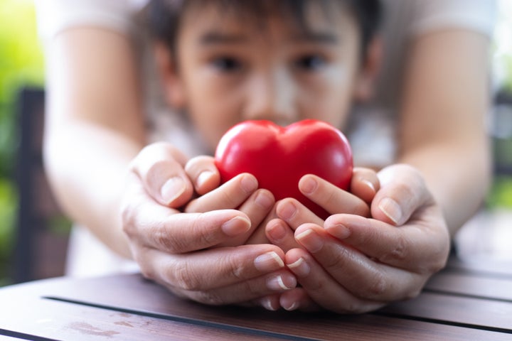 Women hand holding heart, heart disease concept