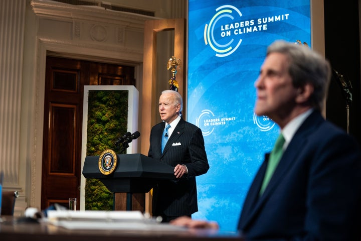 President Joe Biden delivers remarks as John Kerry, special presidential envoy for climate, listens at the virtual Leaders Summit on Climate at the White House in April. Biden pledged to cut greenhouse gas emissions by half by 2030.