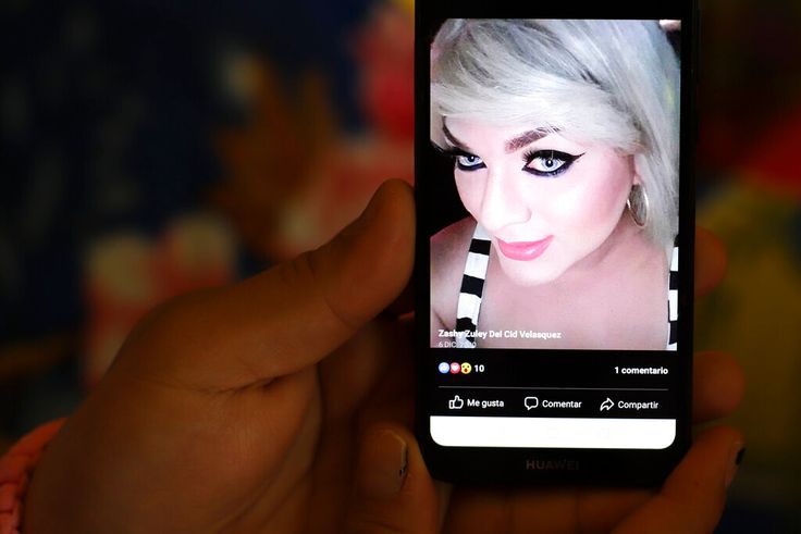 A friend shows a digital picture of Zashy Zuley del Cid Velasquez on a mobile device, in San Miguel, El Salvador, Tuesday, May 25, 2021. The 27-year-old Del Cid was shot dead April 25, sending shockwaves through the city's close-knit LGBTQ community. 