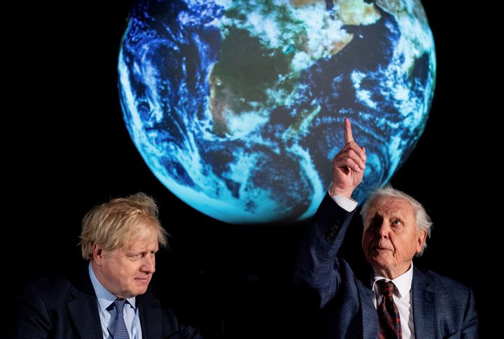 Britain's Prime Minister Boris Johnson sits with British broadcaster and conservationist David Attenborough, during an event to launch the United Nations' Climate Change conference, COP26, in central London on February 4, 2020.