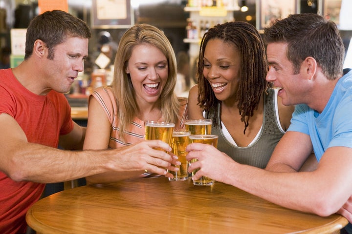 group of young friends toasting ...