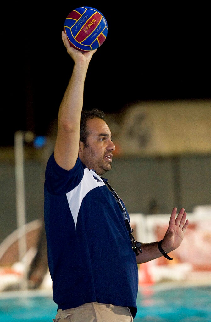 Bahram Hojreh coaches youngsters at at the USA Water Polo National Training Center in Los Alamitos, Calif. A dozen female water polo players who accused their coach of sexual abuse will split nearly $14 million after settling a lawsuit against USA Water Polo and a California club. The athletes alleged that International Water Polo Club and the national governing organization for the sport failed to protect them from abuse by coach Bahram Hojreh from 2012 to 2017. (Rose Palmisano/The Orange County Register via AP, File)