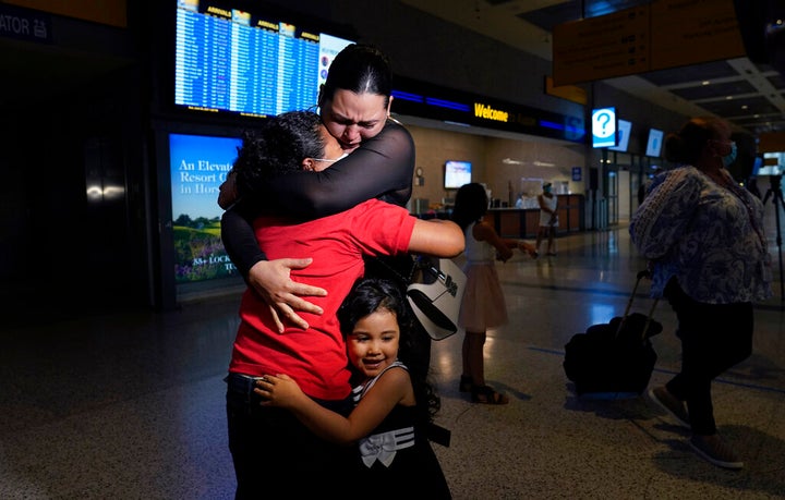 Emely, left, is reunited with her mother, Glenda Valdez and sister, Zuri, at Austin-Bergstrom International Airport, Sunday,