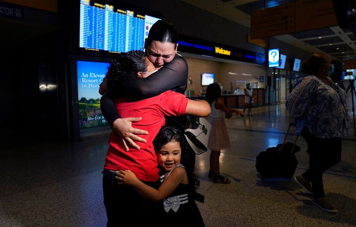 Emely, left, is reunited with her mother, Glenda Valdez and sister, Zuri, at Austin-Bergstrom International Airport, Sunday, June 6, 2021, in Austin, Texas. It had been six years since Valdez said goodbye to her daughter Emely in Honduras. Then, last month, she caught a glimpse of a televised Associated Press photo of a little girl in a red hoodie and knew that Emely had made the trip alone into the United States. On Sunday, the child was returned to her motherâs custody. (AP Photo/Eric Gay)