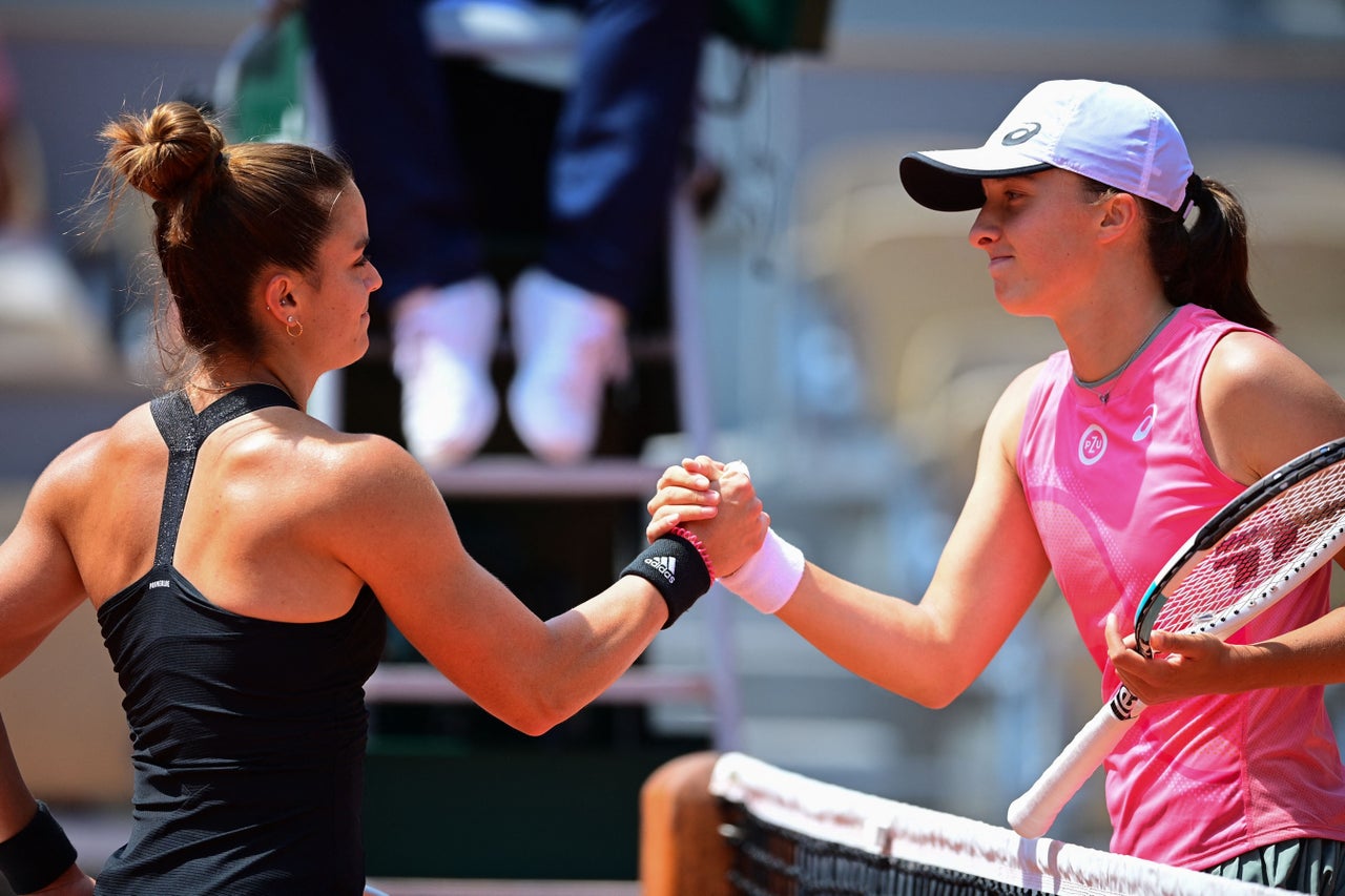 Greece's Maria Sakkari (L) and Poland's Iga Swiatek shake hands at the end of their women's singles quarter-final tennis match on Day 11 of The Roland Garros 2021 French Open tennis tournament in Paris on June 9, 2021. (Photo by MARTIN BUREAU / AFP) (Photo by MARTIN BUREAU/AFP via Getty Images)