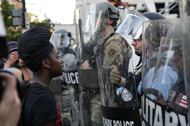 Security forces block the road as protesters gather near Lafayette Park ahead of President Donald Trump's trip to St. John's
