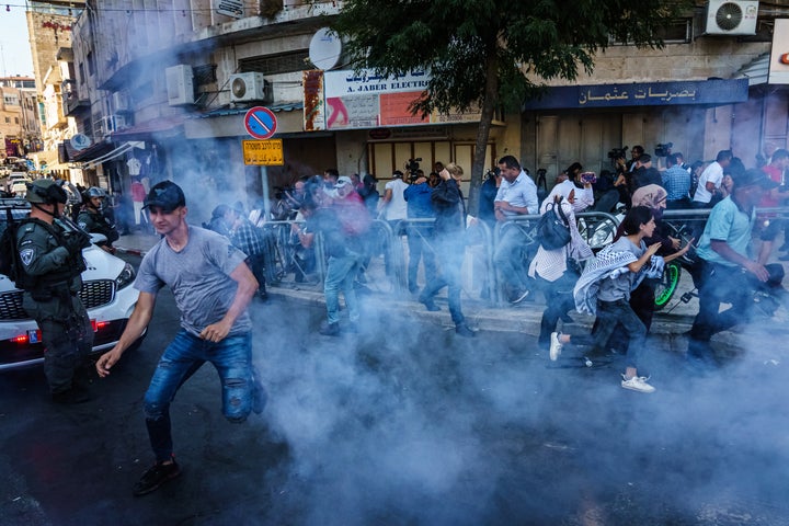 Israeli security forces throw stun grenades Sunday to disperse a crowd gathered for a news conference calling for the release of Muna el-Kurd and Mohammed el-Kurd, two prominent activists in the Sheikh Jarrah neighborhood in East Jerusalem.