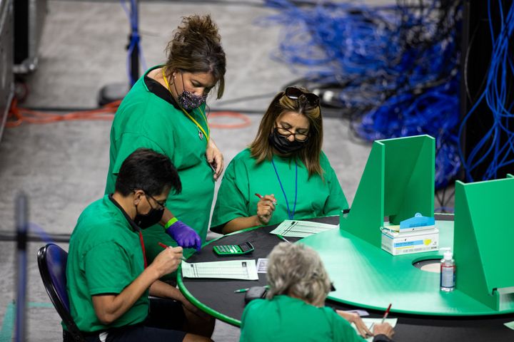 Contractors working for Cyber Ninjas, which was hired by the Arizona state Senate, examine and recount ballots from the 2020 general election in May in Phoenix.
