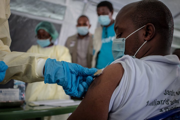 GOMA, DEMOCRATIC REPUBLIC OF CONGO - MAY 05: A health worker vaccinates a citizen with AstraZeneca during the vaccination campaign as part of the vaccination campaign against COVID-19 on May 05, 2021 in Goma, Democratic Republic of Congo. The central African country received 1.7 million AstraZeneca vaccine doses through the UN-led COVAX facility in March. (Photo by Guerchom Ndebo/Getty Images)