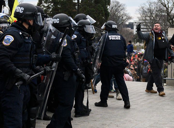Russ Taylor, right, flips off cops at the Capitol.