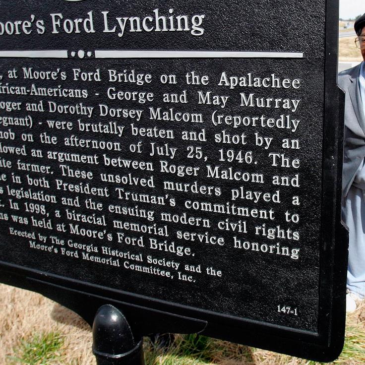 This Feb. 12, 2005, file photos shows Rosa Ingram, Roger Malcom's aunt, reading the Georgia Historical Society marker for the Moore's Ford bridge lynching, outside Monroe, Georgia. The brazen mass lynching horrified the nation that year but no one was ever indicted and investigations over the years failed to solve the case.