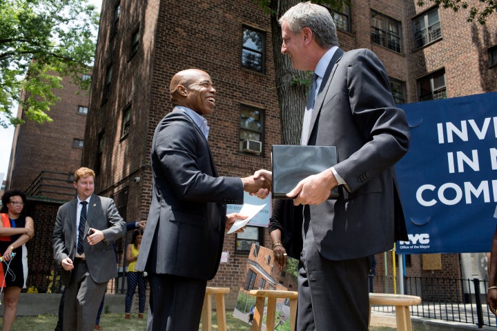Some progressives see Adams' ties to Mayor Bill de Blasio, right, as a selling point. Others see it as a sign that he would h