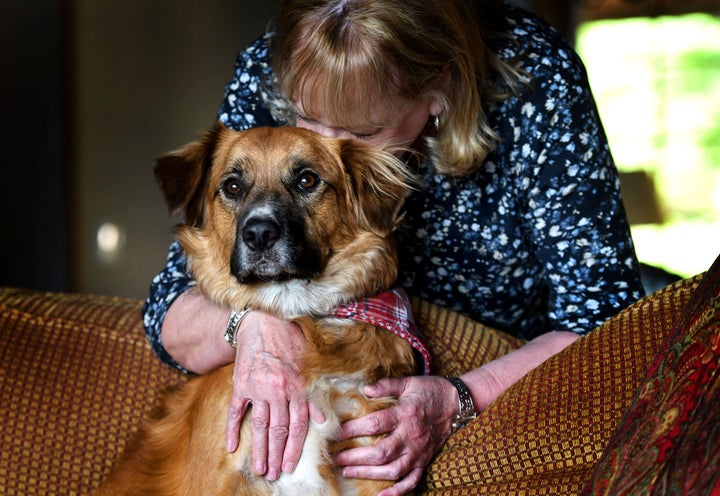 Linda Oswald hugs 2-year-old dog Tilly at their home in Hayden, Idaho on Tuesday, June 8, 2021. (Kathy Plonka/The Spokesman-Review via AP)