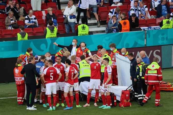 Denmark's players gather around teammate Christian Eriksen, who collapsed on the pitch during a match between Denmark and Finland at the Parken Stadium in Copenhagen on Saturday.