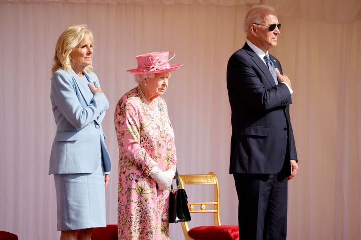 President Joe Biden and First Lady Jill Biden stand beside Britain's Queen Elizabeth II as a Guard of Honour give a Royal Salute during the U.S. National Anthem at Windsor Castle in Windsor, west of London, on Sunday.