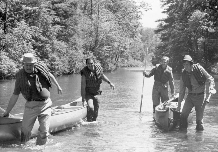 1972, Left to right: American actors Ned Beatty, Burt Reynolds, Jon Voight and Ronny Cox pull their canoes through the shallo