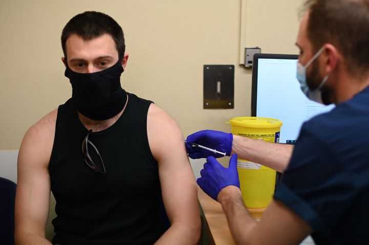 A student receives a dose of the Pfizer/BioNTech Covid-19 vaccine at a vaccination centre at the Hunter Street Health Centre in London on June 5, 2021.