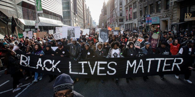 Demonstrators march in New York, Saturday, Dec. 13, 2014, during the Justice for All rally and march. In the past three weeks, grand juries have decided not to indict officers in the chokehold death of Eric Garner in New York and the fatal shooting of Michael Brown in Ferguson, Mo. The decisions have unleashed demonstrations and questions about police conduct and whether local prosecutors are the best choice for investigating police. (AP Photo/John Minchillo)