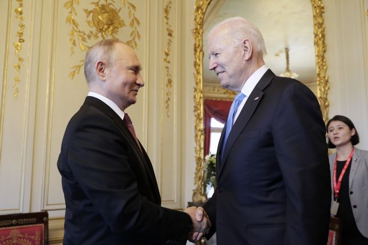 Russia's President Vladimir Putin and President Joe Biden shake hands as they meet for talks at the Villa La Grange in Geneva.
