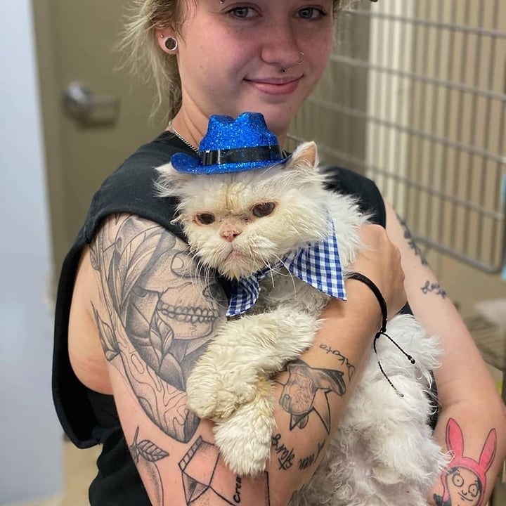 A shelter staff member with Sammy, dressed to impress.