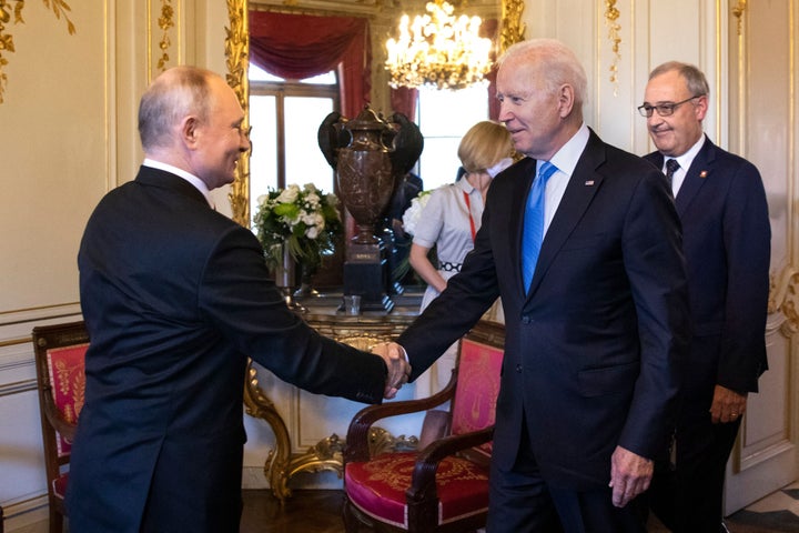 Joe Biden and Vladimir Putin shake hands at their meeting in Geneva.