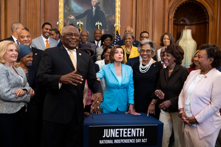 Democrats attend a bill enrollment ceremony for the Juneteenth National Independence Day Act in the Capitol on June 17, 2021. In the front row, from left, are Reps. Carolyn Maloney (D-N.Y.) and Ilhan Omar (D-Minn.), House Majority Whip Jim Clyburn (D-S.C.), Speaker of the House Nancy Pelosi (D-Calif.), and Reps. Joyce Beatty (D-Ohio), Maxine Waters (D-Calif.) and Barbara Lee (D-Calif.).