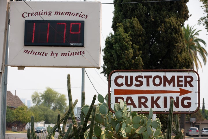 A thermometer sign displays a temperature of 117 degrees Fahrenheit on Tuesday in Phoenix.