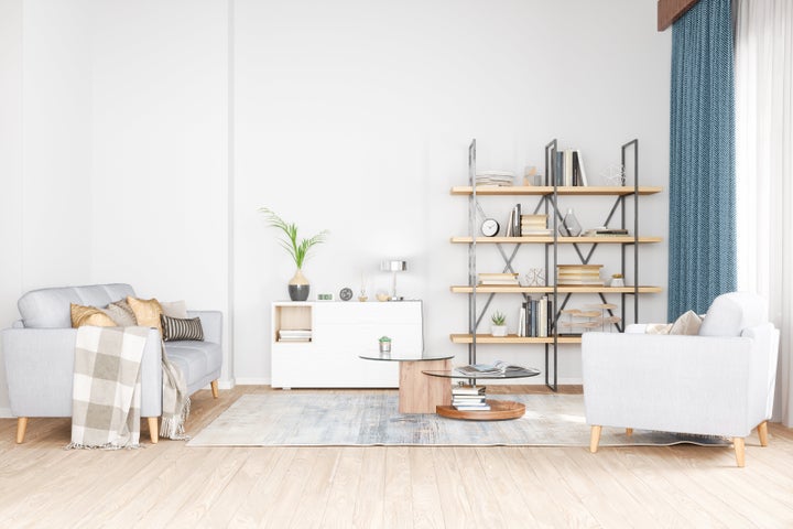 Bookshelf, armchair and sofa in living room