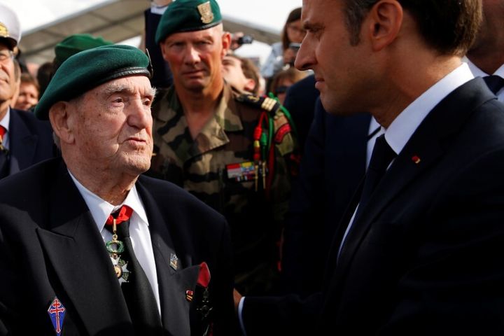 Ο Εμανουέλ Μακρόν ακούει με προσοχή τον Γάλλο βετεράνο του Β' Παγκοσμίου Πολέμου Λεόν Γκοτιέ. Francois Mori/Pool via REUTERS/File Photo