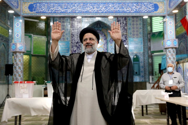 Ebrahim Raisi waves to the media after casting his vote at a polling station in Tehran, Iran Friday, June 18, 2021. (AP Photo