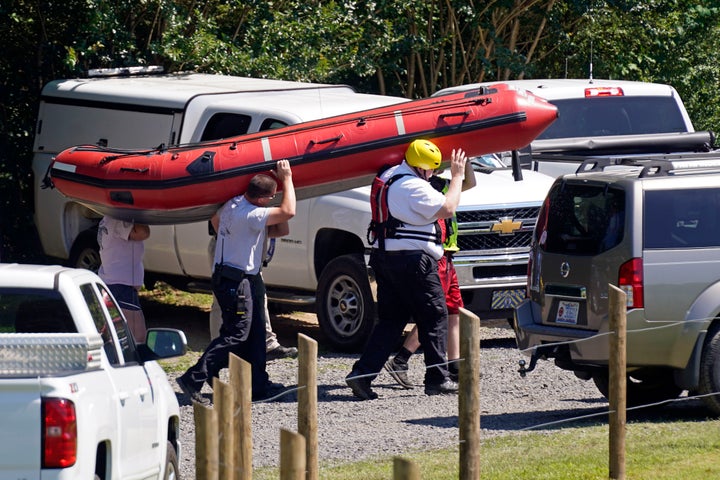 The search for two missing tubers continues after three others were found dead and four more were pulled from the water after the group went over an 8-foot dam Wednesday. (AP Photo/Gerry Broome)