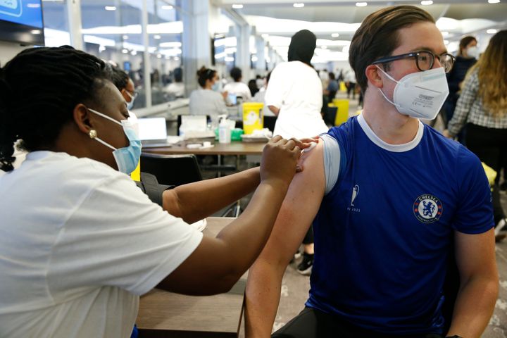 LONDON, ENGLAND - JUNE 19: A man receives a vaccine at the Chelsea F.C. pop up vaccine hub on June 19, 2021 in London, England. Chelsea F.C. is offering Covid-19 jabs to all eligible locals over the age of 18. (Photo by Hollie Adams/Getty Images)