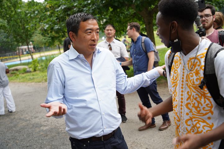 Andrew Yang talks to a voter in Manhattan's Morningside Park on Saturday. Once a frontrunner, the businessman and former presidential candidate has slid in recent polls.