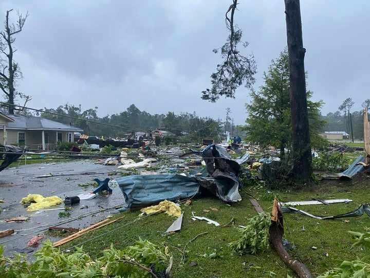 This photo provided by Alicia Jossey shows debris covering the street in East Brewton, Ala., on Saturday, June 19, 2021. Authorities in Alabama say a suspected tornado spurred by Tropical Storm Claudette demolished or badly damaged at least 50 homes in the small town just north of the Florida border. (Alicia Jossey via AP)