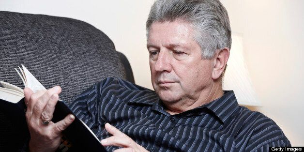 Mature man reading book