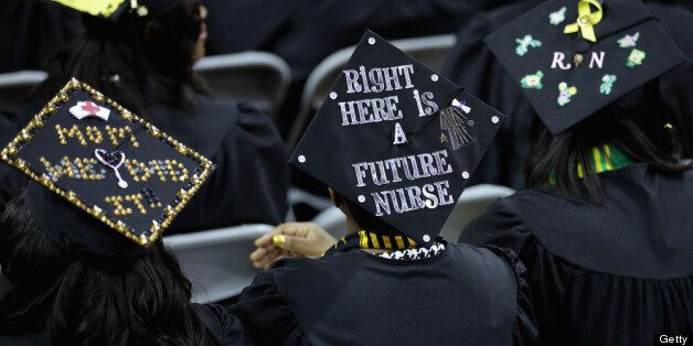 COLLEGE PARK, MD - MAY 17: Graduates of Bowie State University put messages on their mortarboard hats during the school's graduation ceremony at the Comcast Center on the campus of the University of Maryland May 17, 2013 in College Park, Maryland. First lady Michelle Obama delivered the commencement speech for the 600 graduates of Maryland's oldest historically black university and one of the ten oldest in the country. (Photo by Chip Somodevilla/Getty Images)