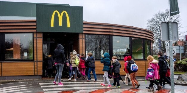 Youngsters enter the McDonald's fast-food outlet on February 26, 2015 in Lille, northern France. Several labour unions and a