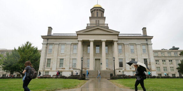 FILE - In this Oct. 2, 2014 file photo, students walk across campus at the University of Iowa in Iowa City, Iowa. University of Iowa President Sally Mason says Tuesday, Nov. 18, 2014 she would have concerns about extending a tuition freeze to cover nonresident and graduate students. (AP Photo/Charlie Neibergall, File)