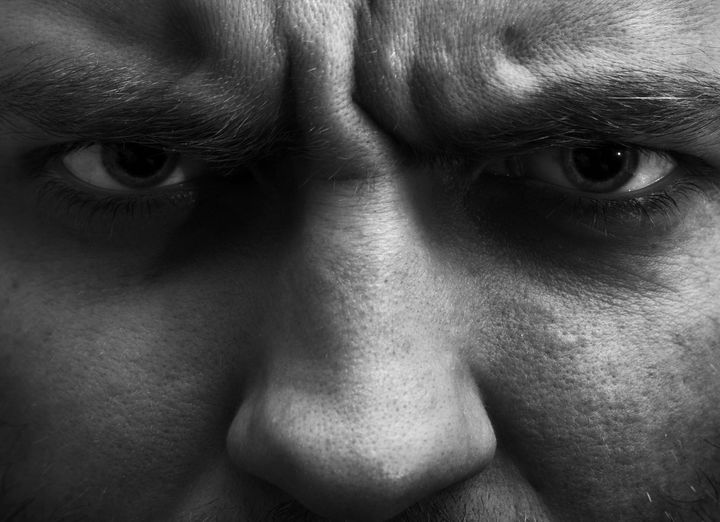 Close-up portrait of angry man. In B/W